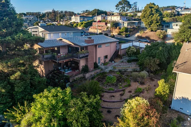 a view of a house with a yard and garden