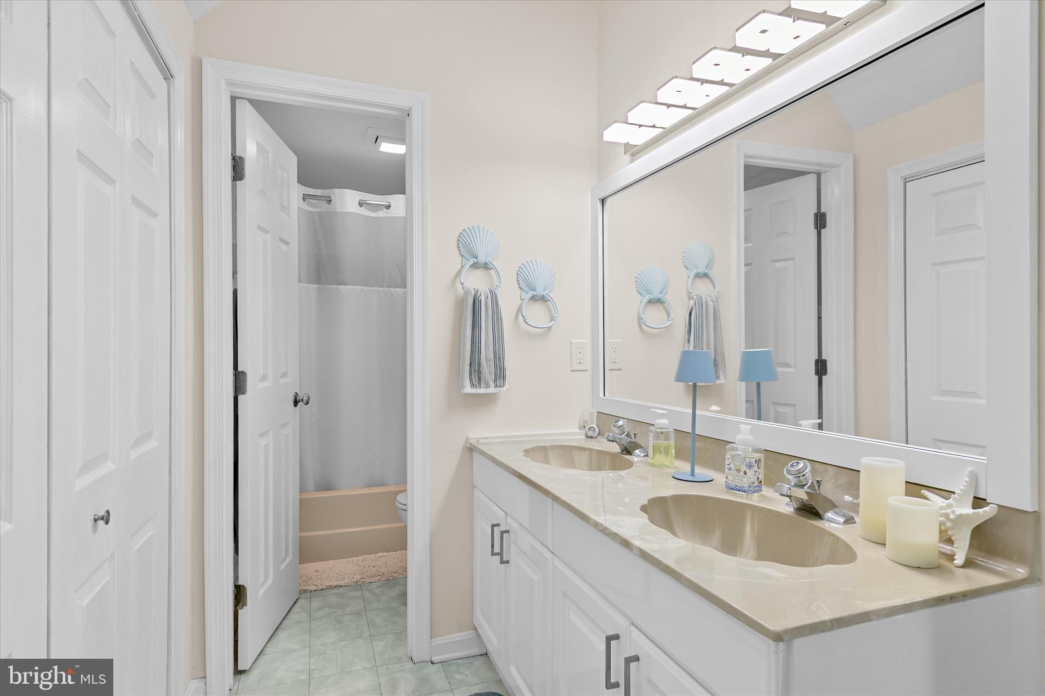 132 Jamestown Road, Unit 601 Ocean City, MD 21842 - Photo 18 of 37 a bathroom with a double vanity sink mirror and double