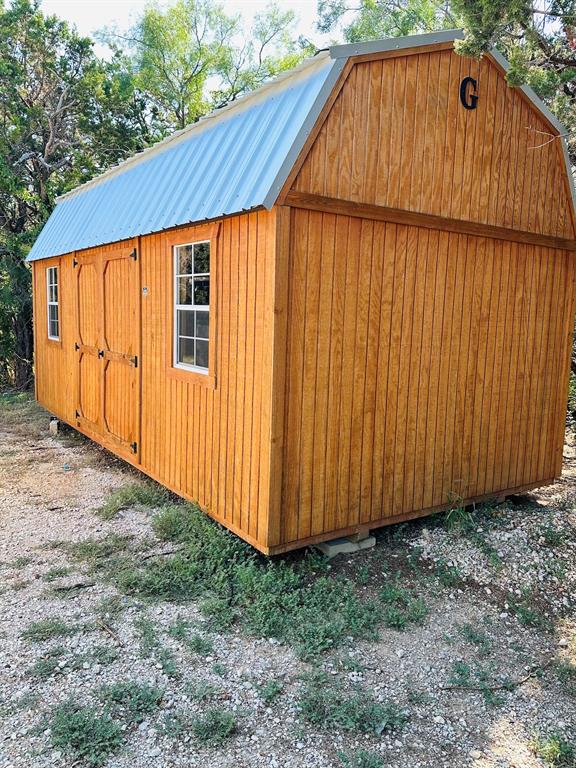 201 Rock Creek Road, Unit 14 Graford, TX 76449 - Photo 14 of 18 a view of backyard with small cabin and wooden fence