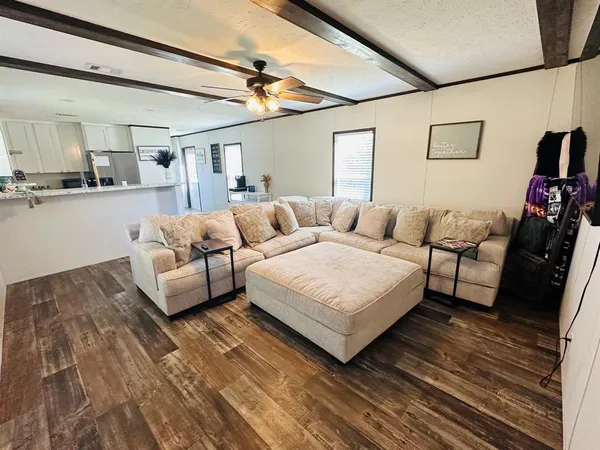 a bedroom with furniture and a wooden floor