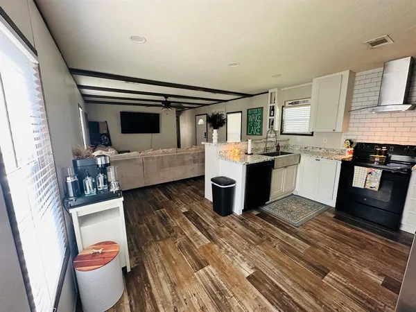 a living room with furniture and flat screen tv