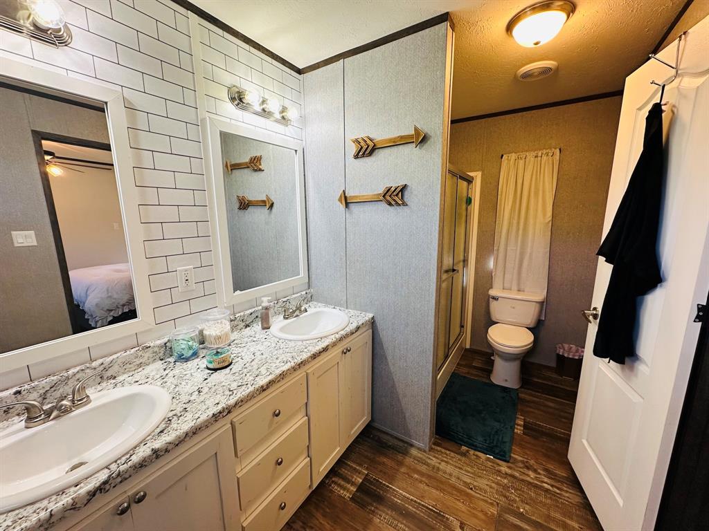 201 Rock Creek Road, Unit 14 Graford, TX 76449 - Photo 10 of 18 a spacious bathroom with a double vanity sink a mirror and shower
