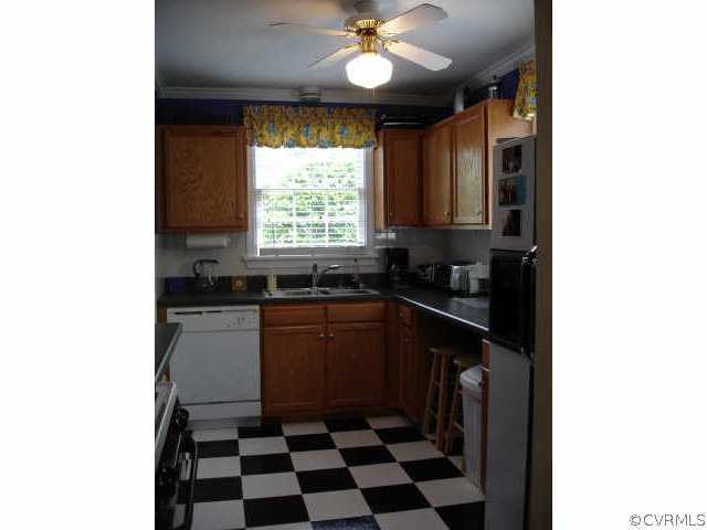1007 Horsepen Road Richmond, VA 23229 - Photo 5 of 8 a kitchen with a refrigerator a sink and cabinets