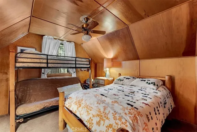 a bedroom with a bed and a ceiling fan