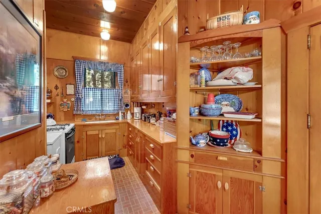 a kitchen with stainless steel appliances a refrigerator and a wooden floor