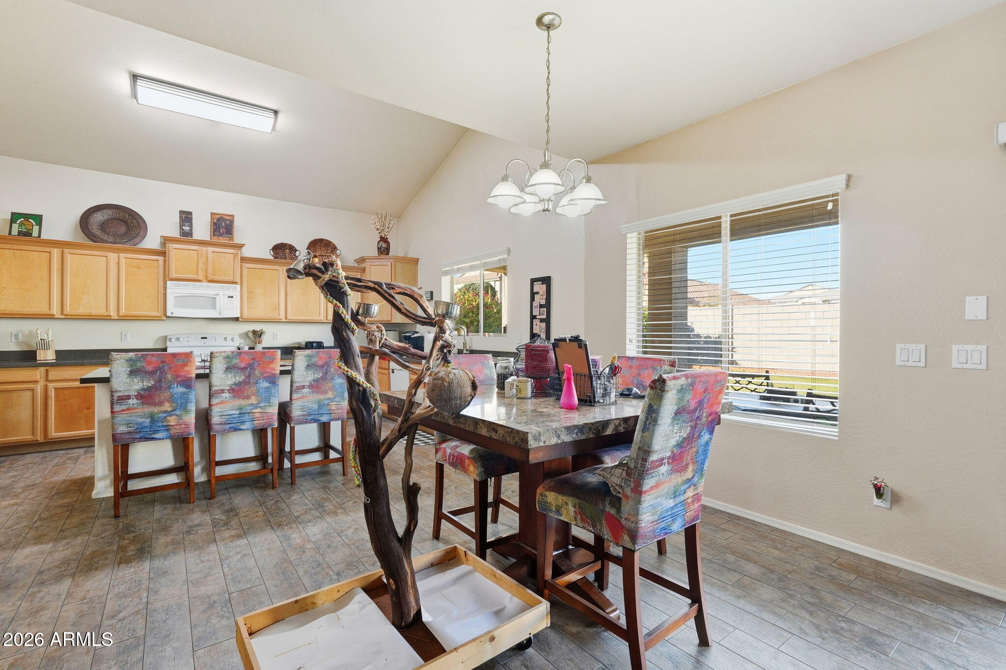 17760 West Charter Oak Road Surprise, AZ 85388 - Photo 19 of 45 a view of a dining room with furniture window and wooden floor