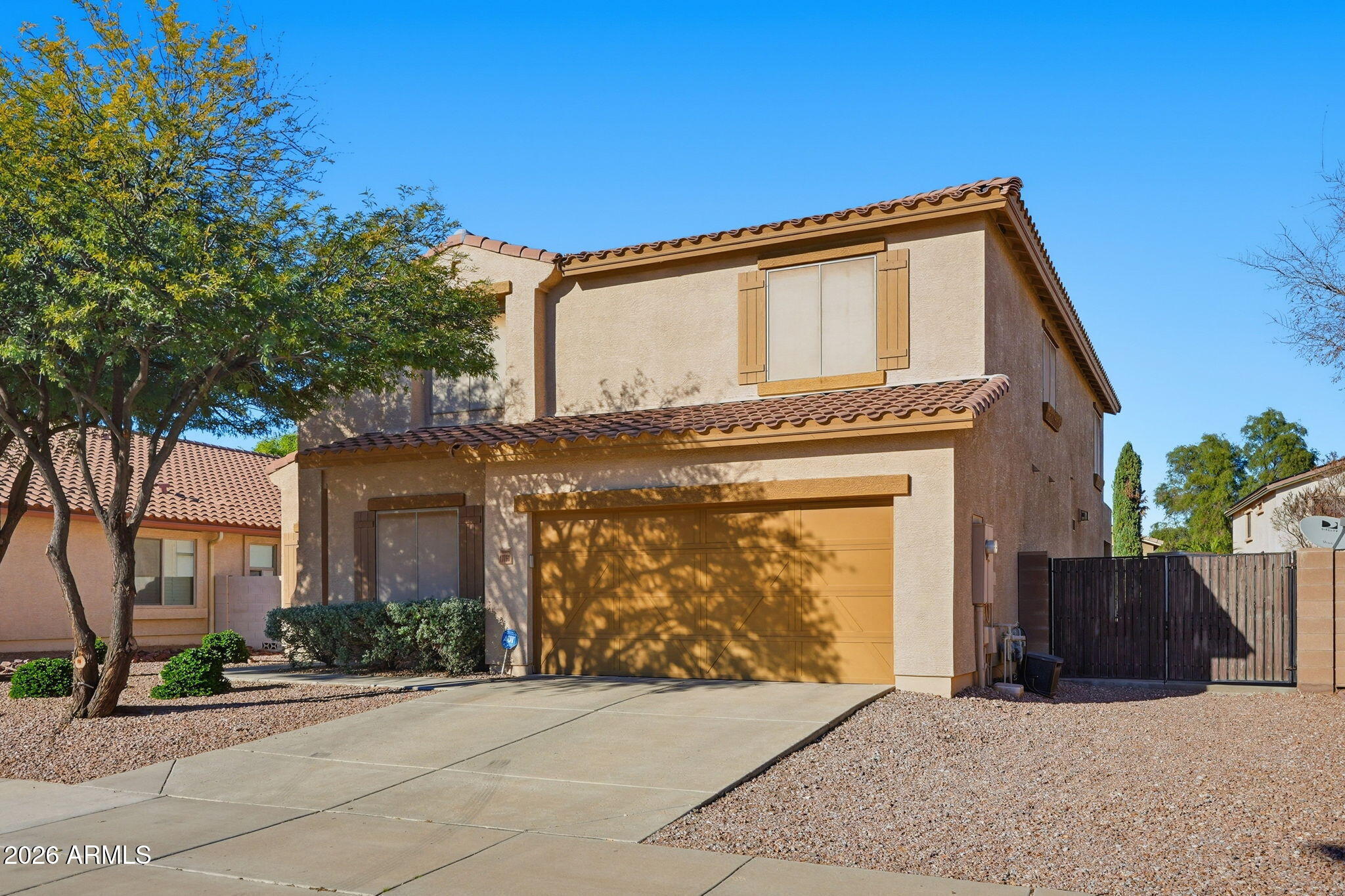 17760 West Charter Oak Road Surprise, AZ 85388 - Photo 2 of 45 a front view of a house with a garden