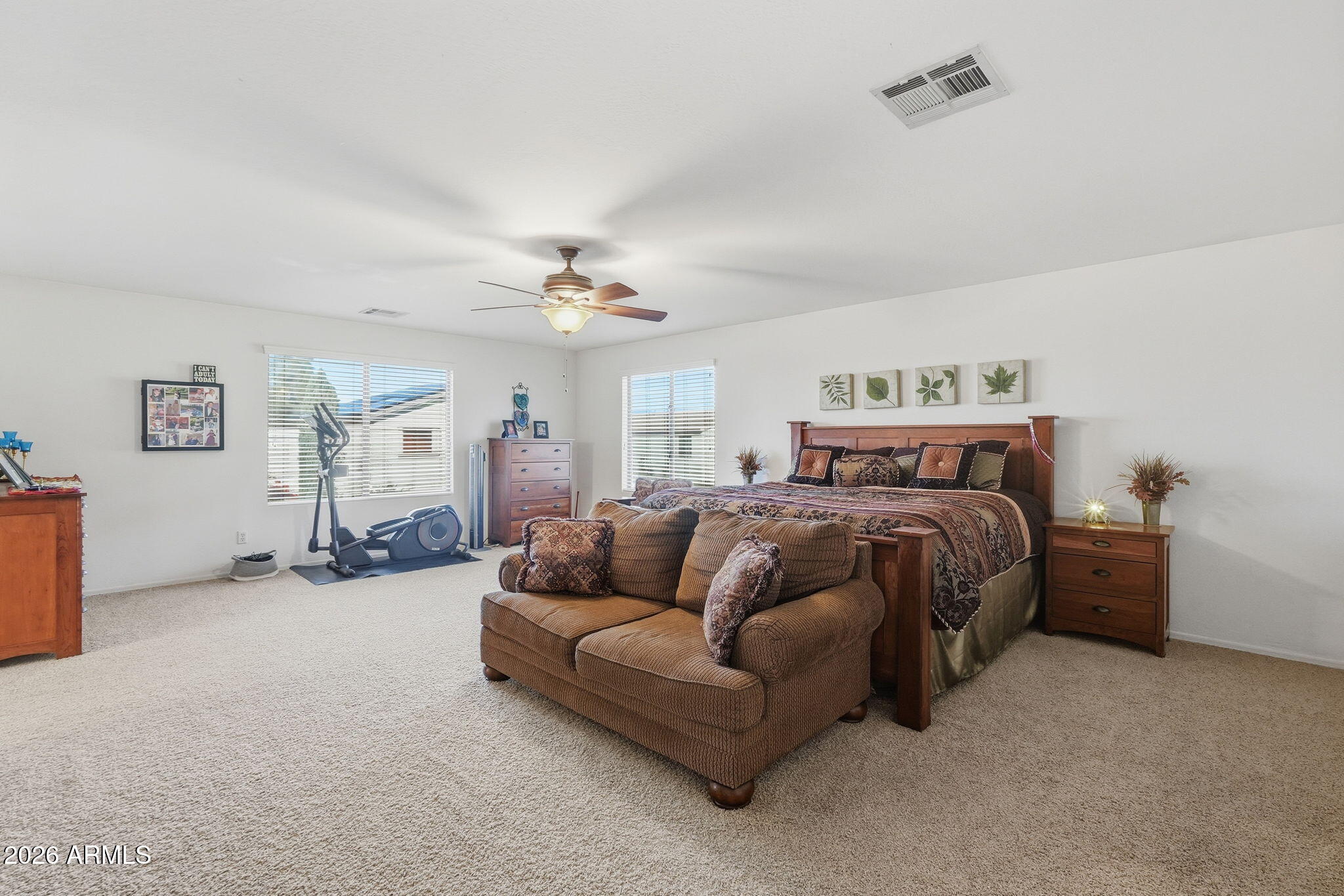 17760 West Charter Oak Road Surprise, AZ 85388 - Photo 21 of 45 a bedroom with a bed couch and dresser