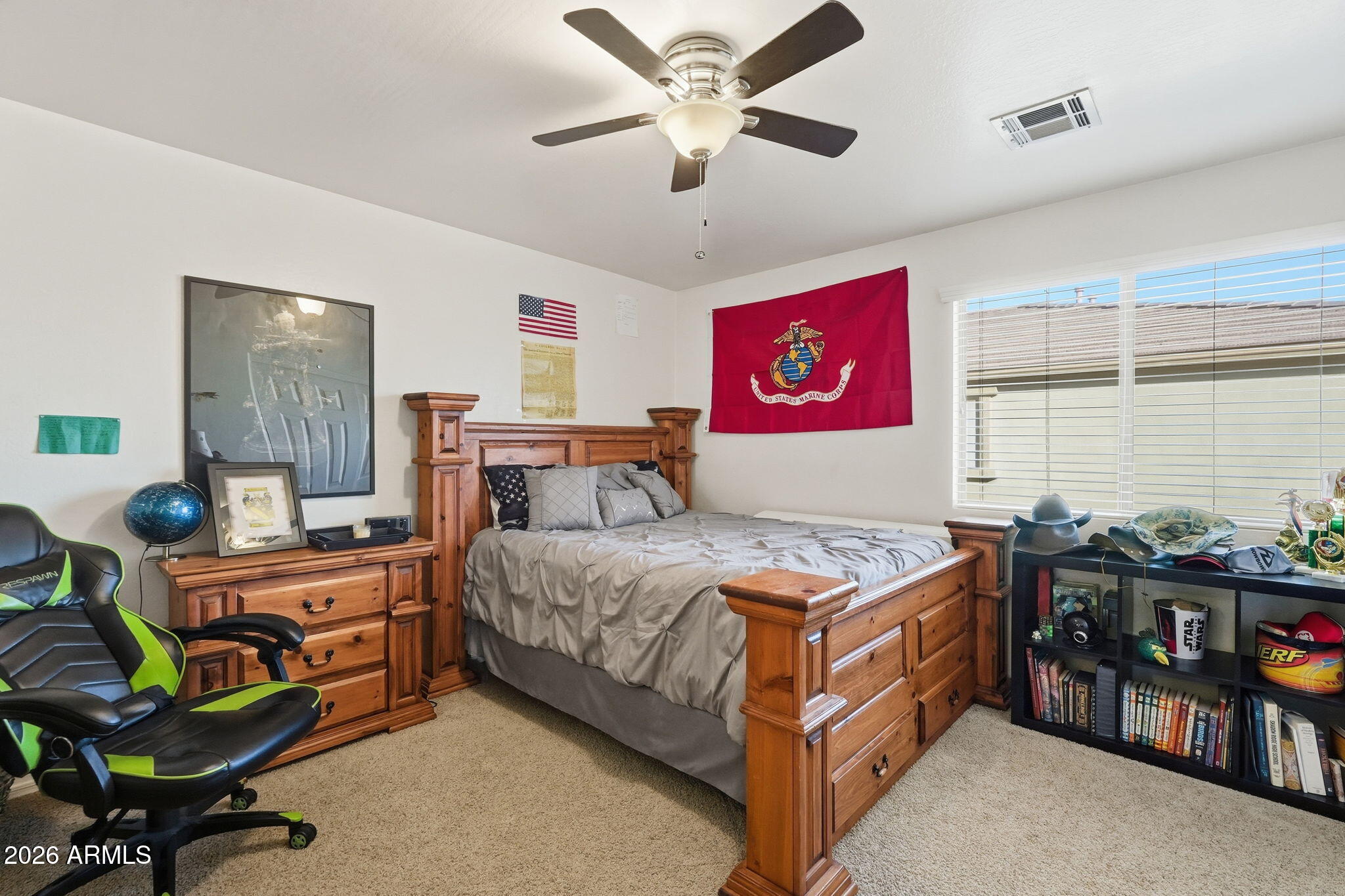 17760 West Charter Oak Road Surprise, AZ 85388 - Photo 26 of 45 a bedroom with a bed and a chandelier