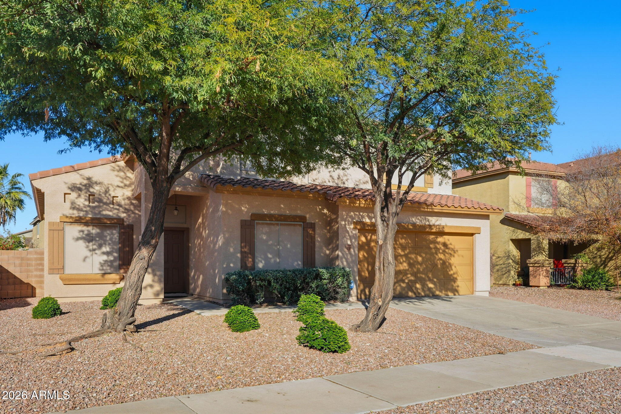 17760 West Charter Oak Road Surprise, AZ 85388 - Photo 3 of 45 front view of a house with a tree
