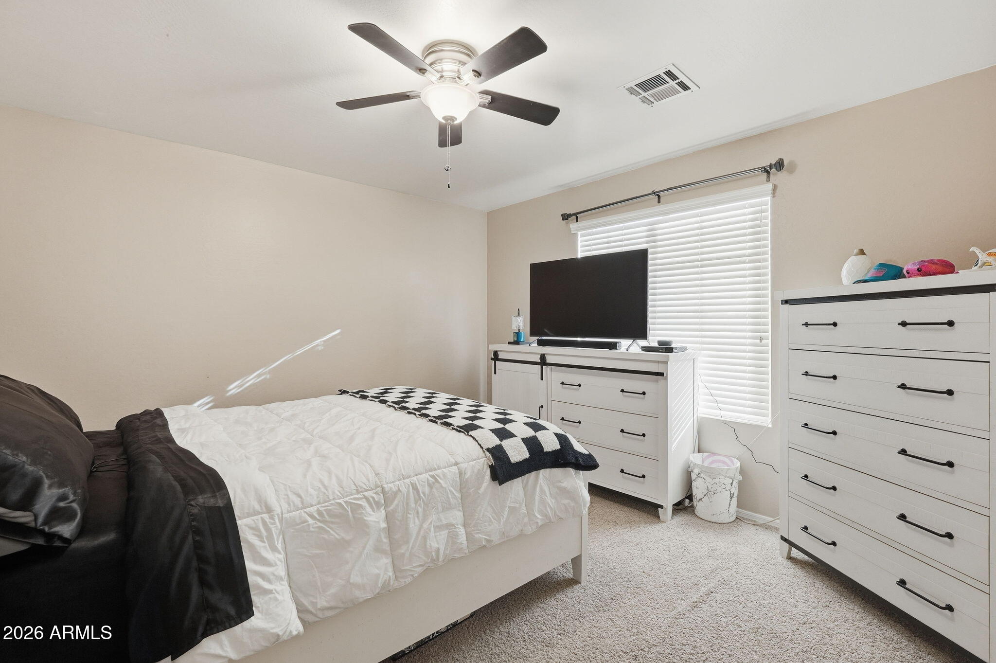 17760 West Charter Oak Road Surprise, AZ 85388 - Photo 31 of 45 a bedroom with a bed and a flat screen tv