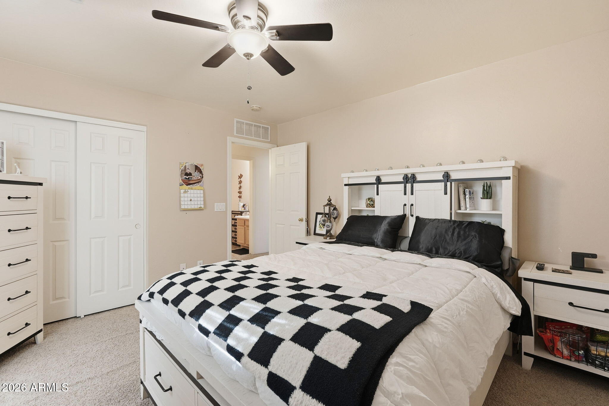 17760 West Charter Oak Road Surprise, AZ 85388 - Photo 32 of 45 a bedroom with a large bed and a chandelier