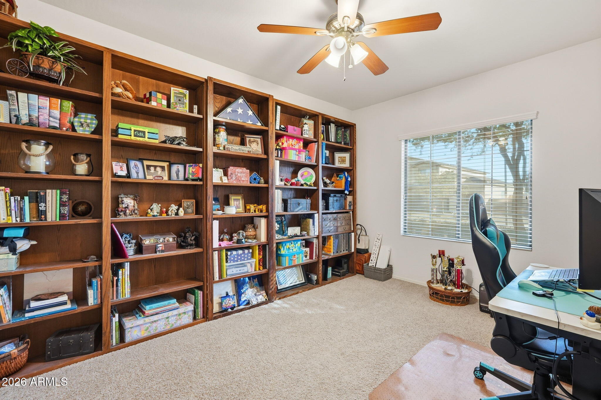 17760 West Charter Oak Road Surprise, AZ 85388 - Photo 33 of 45 a view of a workspace with bookshelf and a window