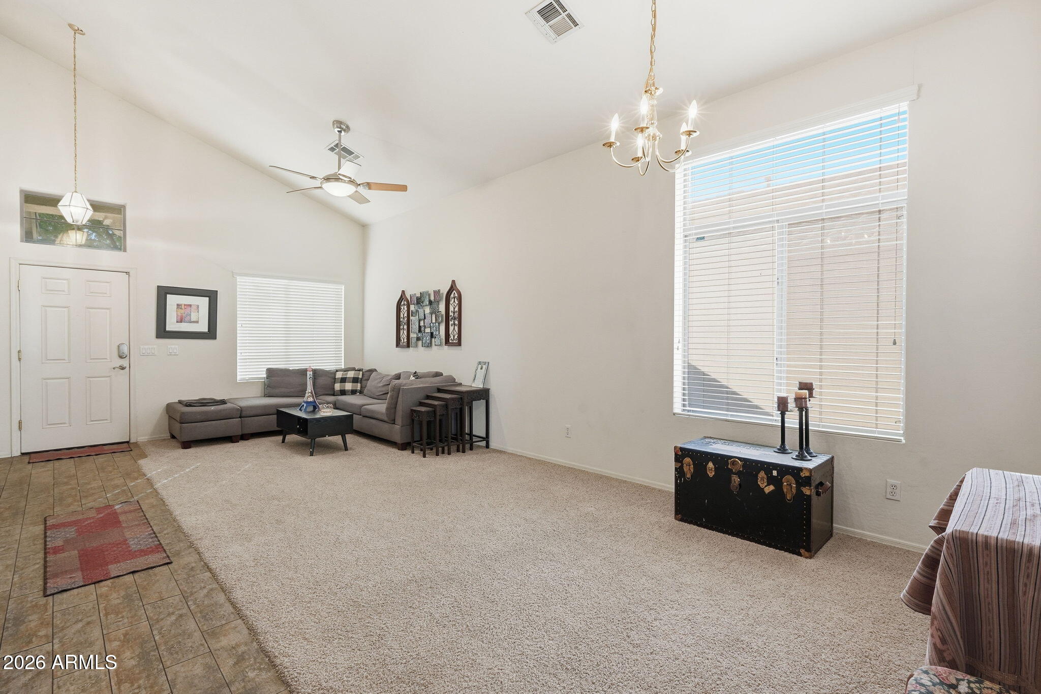 17760 West Charter Oak Road Surprise, AZ 85388 - Photo 6 of 45 a living room with furniture and a chandelier