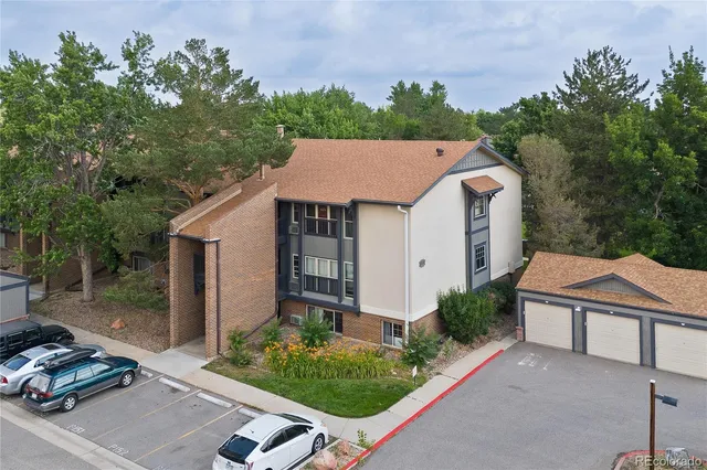 an aerial view of a house with garden space and street view