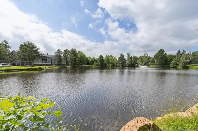 a lake view with boat and trees in the background