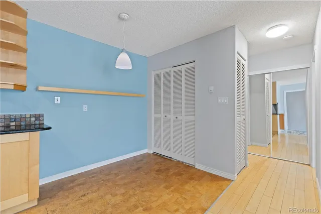 a view of a livingroom with wooden floor and a ceiling fan