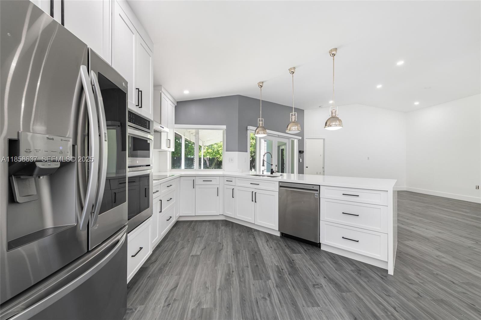 11518 Southwest 174th Street Miami, FL 33157 - Photo 12 of 27 a kitchen with a refrigerator and white cabinets