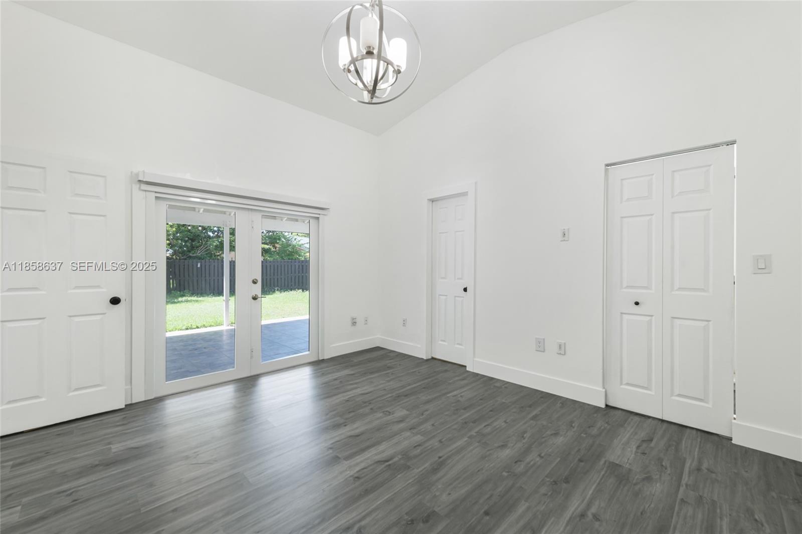 11518 Southwest 174th Street Miami, FL 33157 - Photo 15 of 27 a view of an empty room with wooden floor and a window