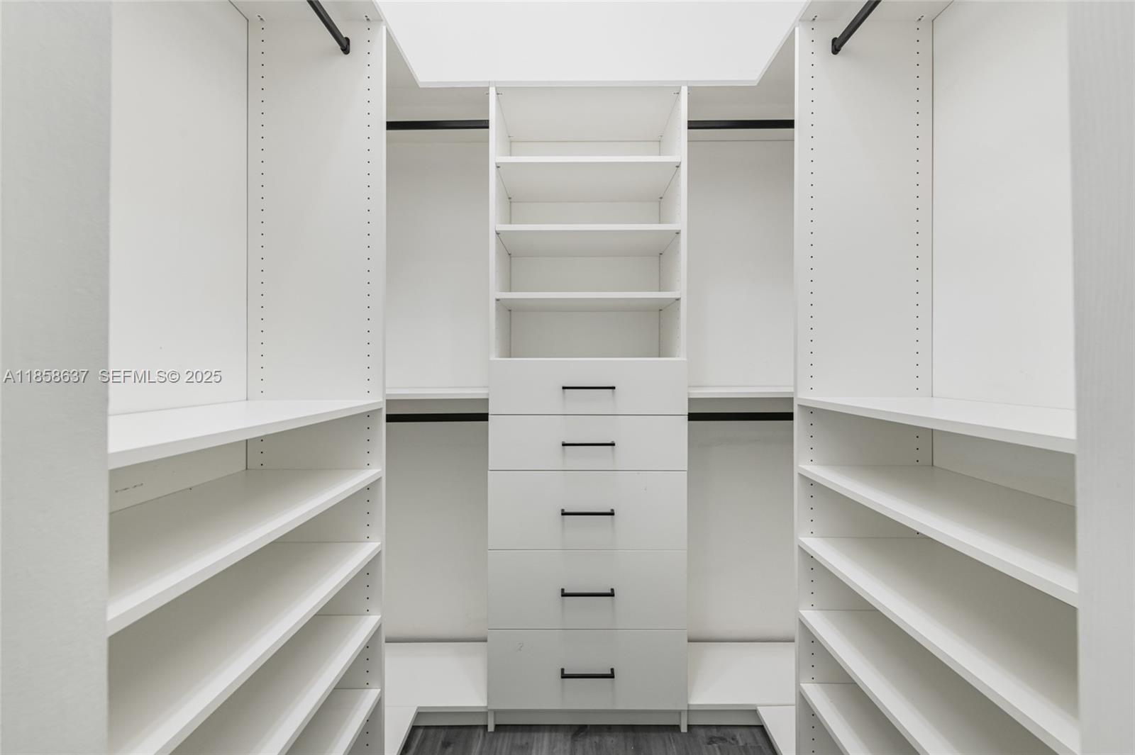 11518 Southwest 174th Street Miami, FL 33157 - Photo 17 of 27 a view of walk in closet with empty racks
