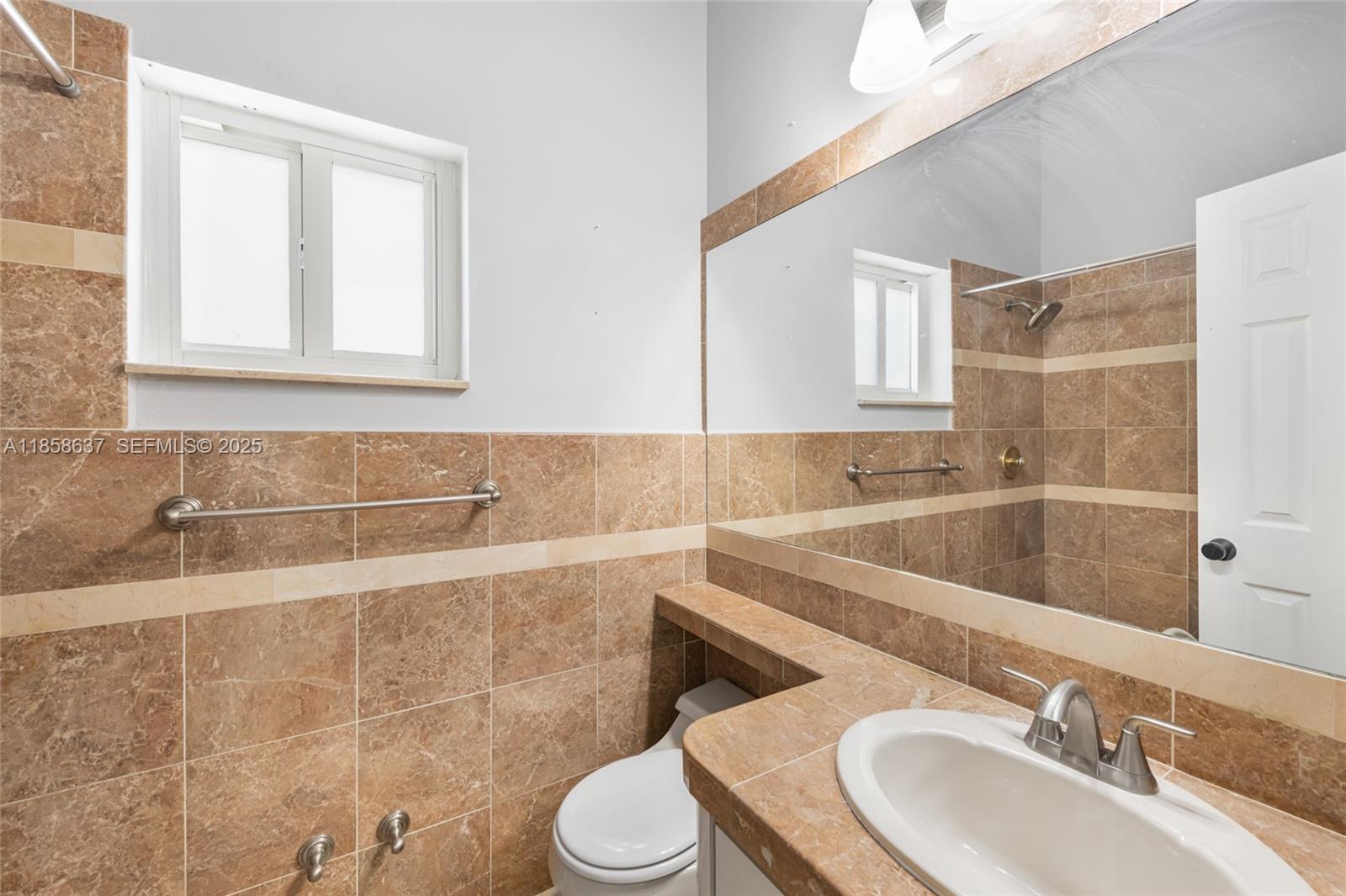11518 Southwest 174th Street Miami, FL 33157 - Photo 18 of 27 a bathroom with a sink and a toilet