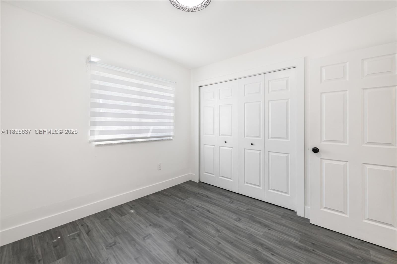 11518 Southwest 174th Street Miami, FL 33157 - Photo 19 of 27 a view of an empty room with wooden floor
