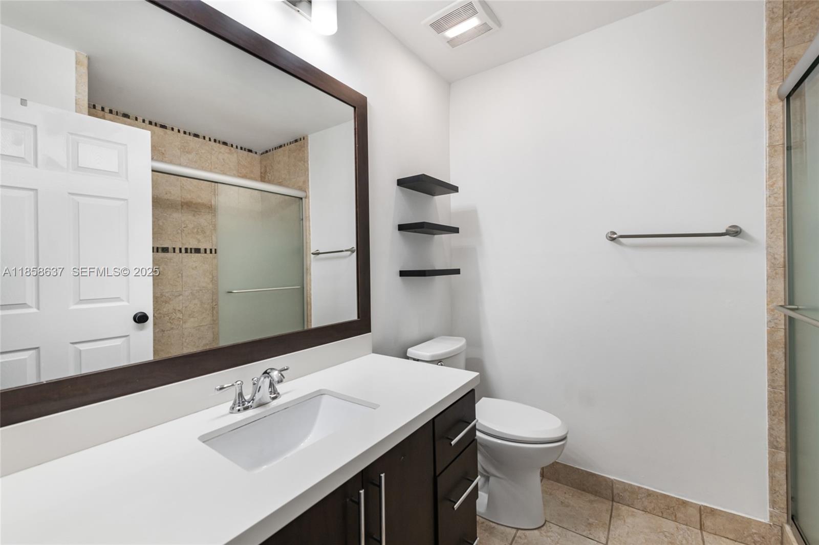 11518 Southwest 174th Street Miami, FL 33157 - Photo 21 of 27 a bathroom with a sink a toilet and shower