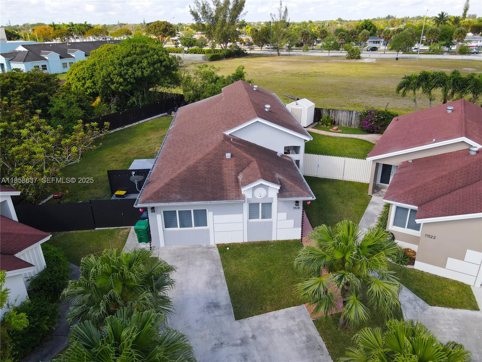 11518 Southwest 174th Street Miami, FL 33157 - Photo 3 of 27 a aerial view of a house with garden space and lake view
