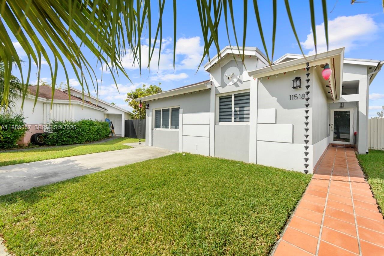 11518 Southwest 174th Street Miami, FL 33157 - Photo 5 of 27 a front view of a house with garden