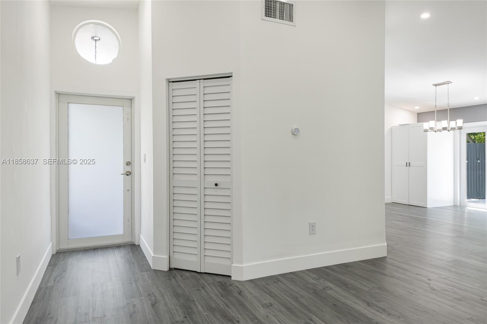 11518 Southwest 174th Street Miami, FL 33157 - Photo 8 of 27 an empty room with wooden floor and a window