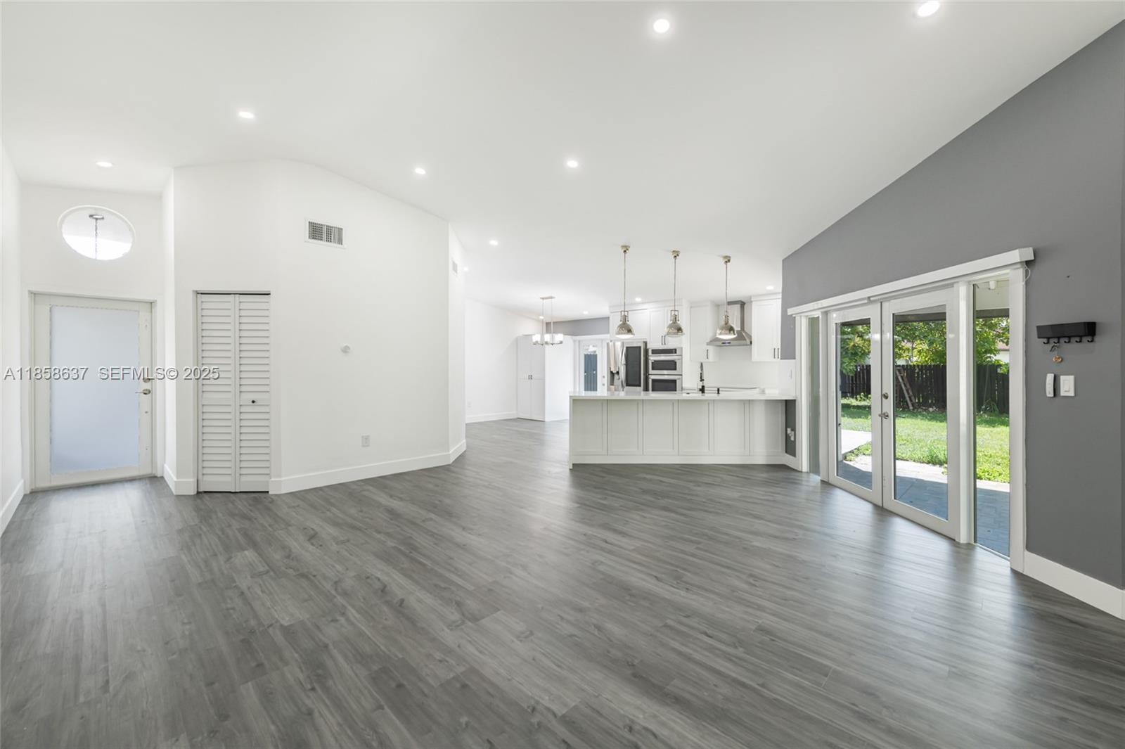 11518 Southwest 174th Street Miami, FL 33157 - Photo 9 of 27 an empty room with wooden floor and windows