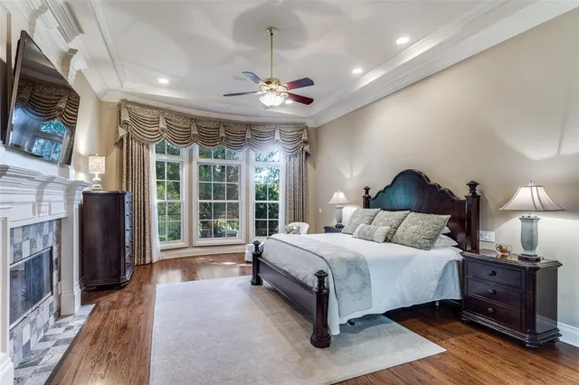 a spacious bedroom with a large bed and a chandelier