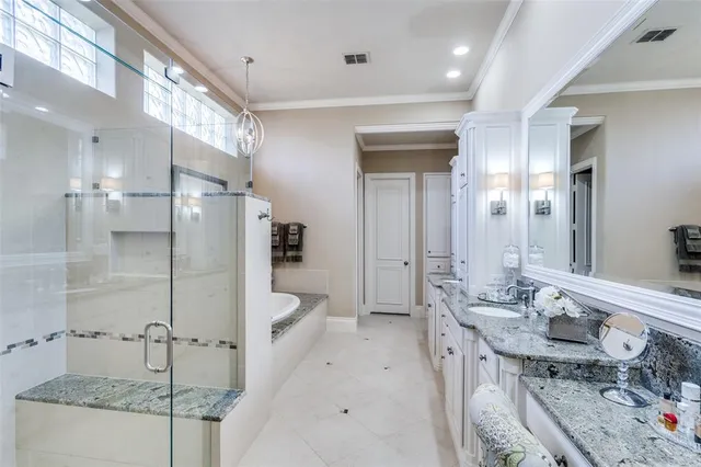 a bathroom with a double vanity sink a mirror and shower