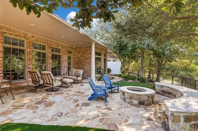 a view of a patio with table and chairs and potted plants