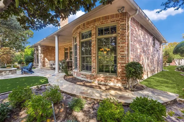 a view of a house with backyard sitting area and garden