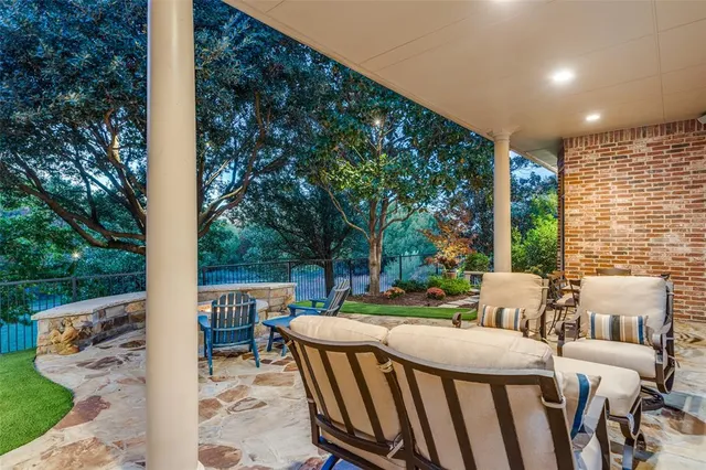 a view of a patio with furniture and garden