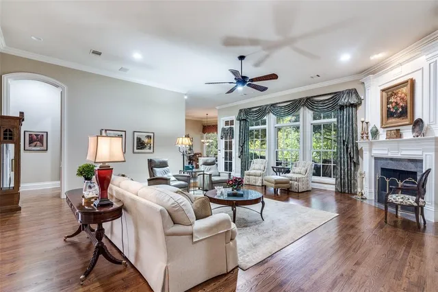a living room with fireplace furniture and a large window