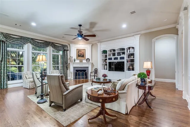 a living room with fireplace furniture and a large window