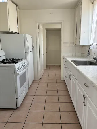 a kitchen with a stove top oven and sink