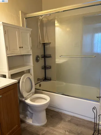a bathroom with a toilet and a shower