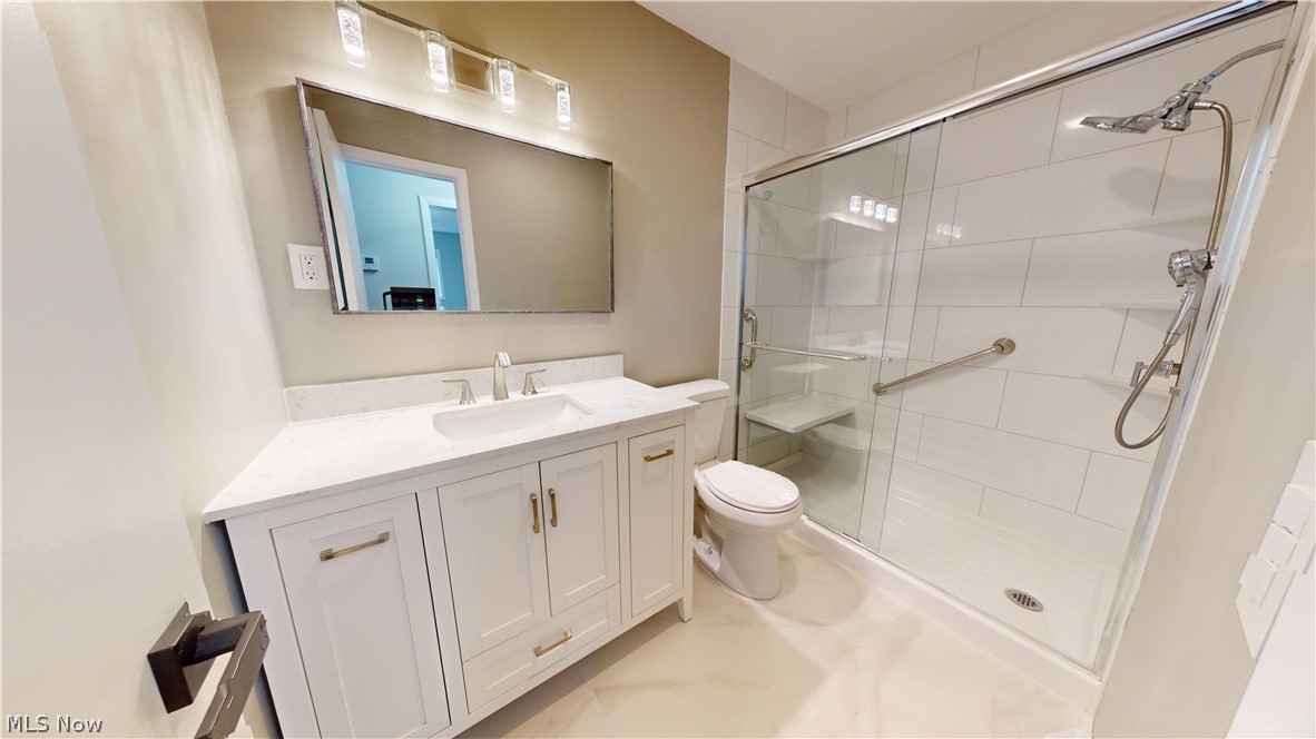 1224 Cordova Road Mayfield Heights, OH 44124 - Photo 19 of 29 Bathroom with a shower with shower door, tile flooring, large vanity, and toilet