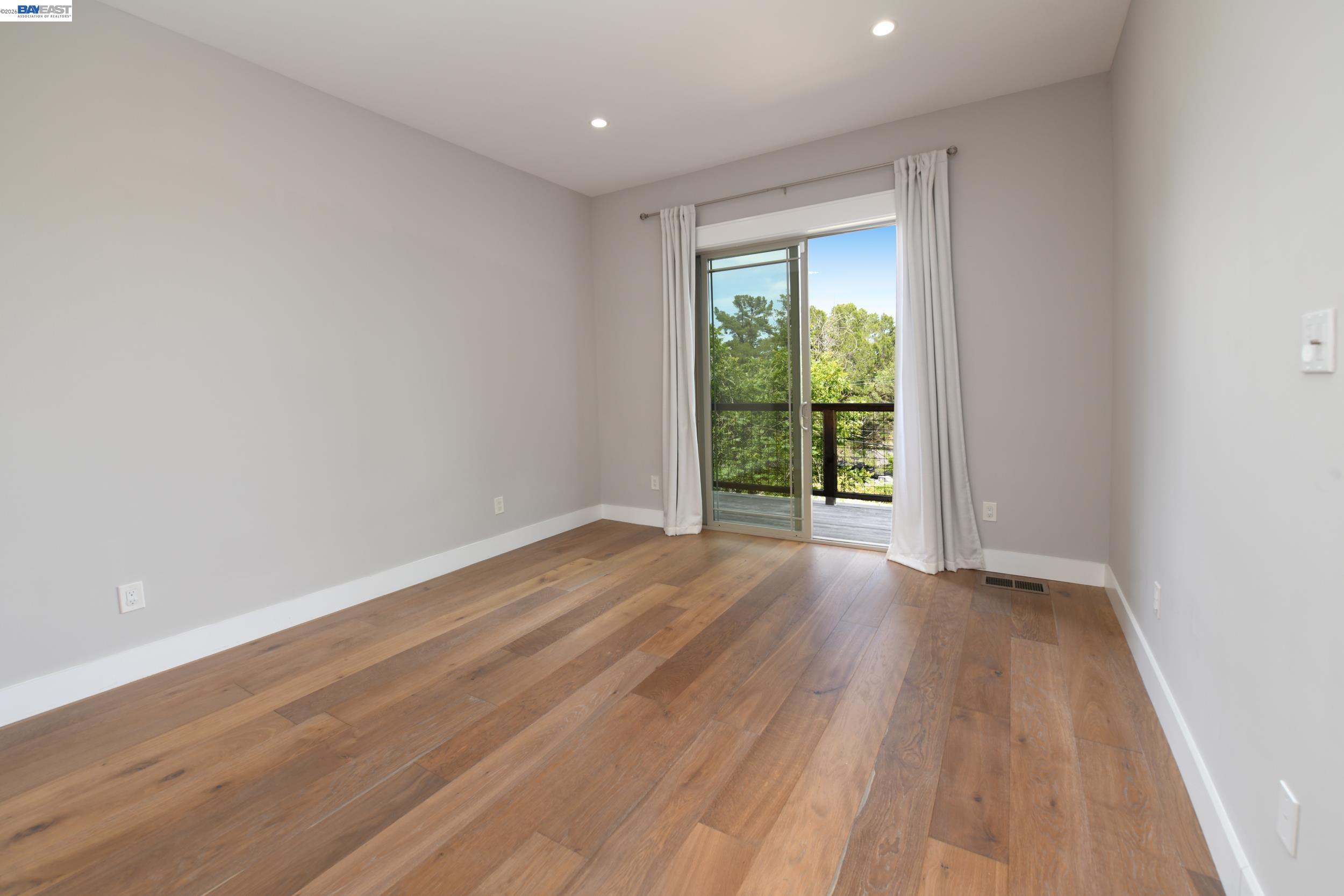 1516 Pleasant Hill Road Lafayette, CA 94549 - Photo 16 of 38 a view of an empty room with wooden floor and a window