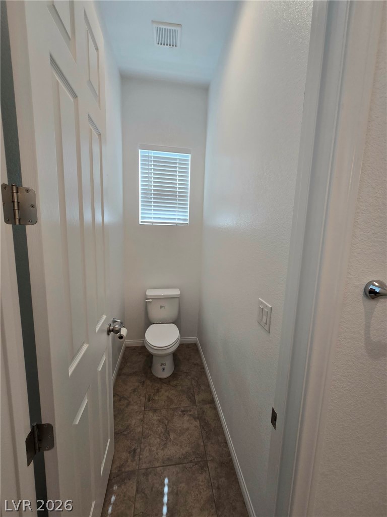 4748 Ritual Street North Las Vegas, NV 89031 - Photo 18 of 31 A well-maintained lavatory with durable tile flooring and a discreet window for natural light.