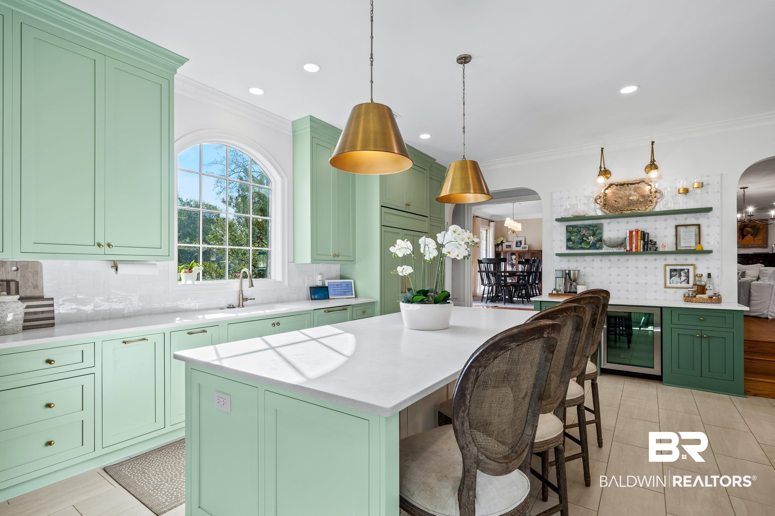 141 Myrtlewood Lane Mobile, AL 36608 - Photo 9 of 44 Kitchen with light countertops, arched walkways, a sink, green cabinetry, and beverage cooler