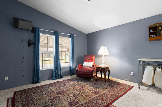 2600 North Hill Field Road, Unit 134 Layton, UT 84041 - Photo 24 of 41 Living area with vaulted ceiling and carpet flooring