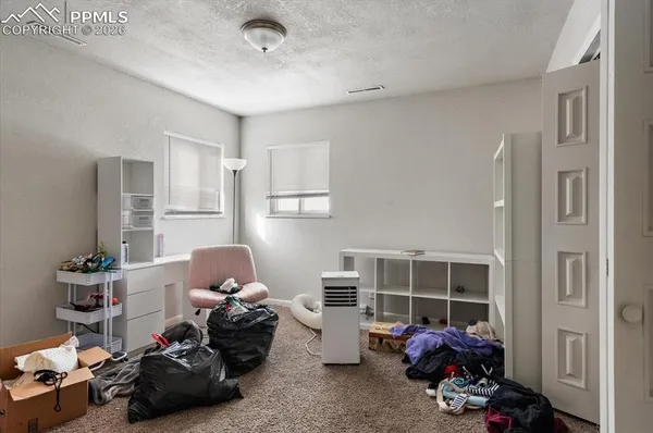 a bedroom with furniture and a window