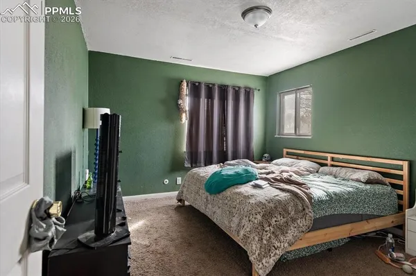 a bedroom with a bed and a mirror