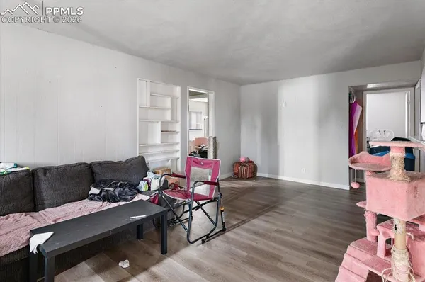 a living room with furniture and wooden floor