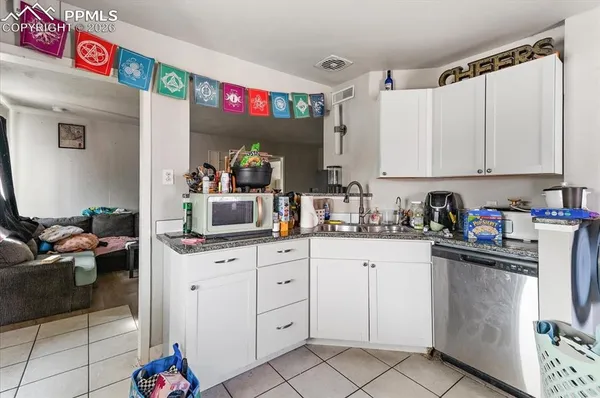 a kitchen with granite countertop a sink and cabinets