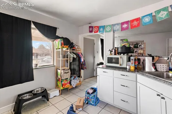 a view of a kitchen with fridge and sink